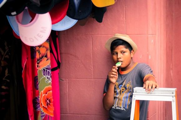 Un nene a cargo de un puesto en la feria callejera de Melaka.